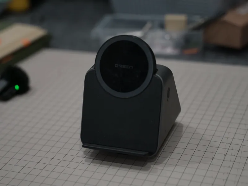 A black commercial MagSafe dock standing on a cutting mat