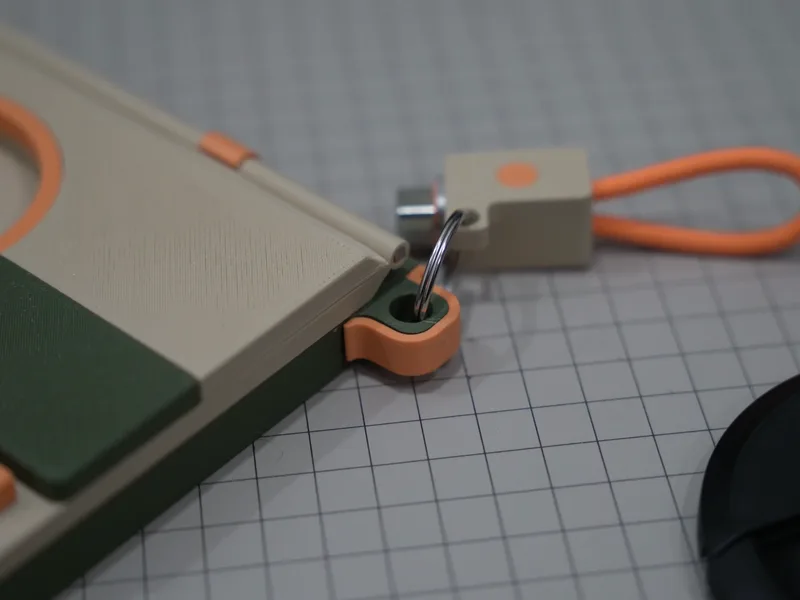 The corner of the dock with its hook, a cable clip hanging from it, the orange cable forming a loop