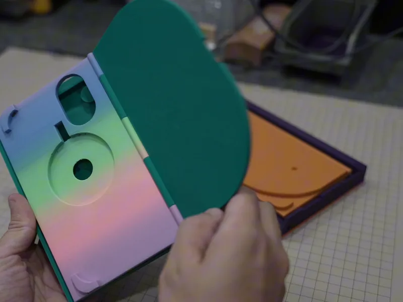 The second prototype, green with a rounded lid, opened