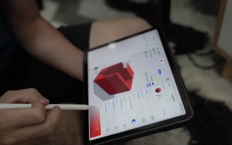 A red box model on the iPad with a clamp on the back
