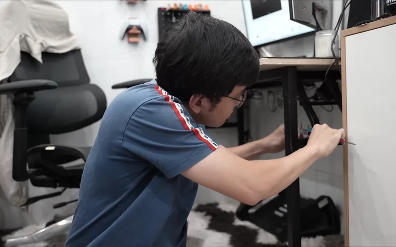 A tape measure against the desk leg