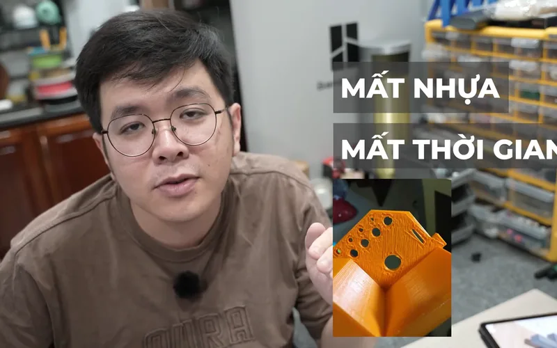Me in the workshop with “Mất nhựa — Mất thời gian” beside an orange part