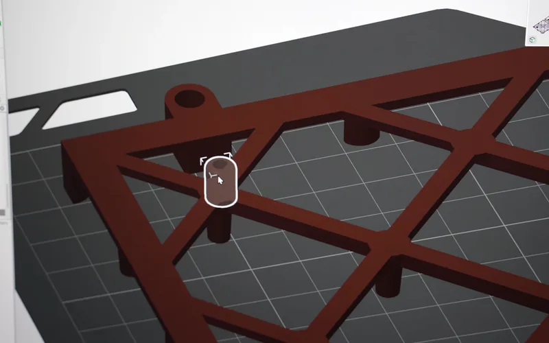 A close-up of a pre-cut hole at a pin position on the model
