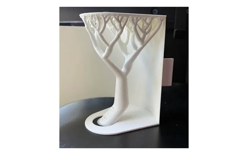 A white print with tree-shaped support beneath it
